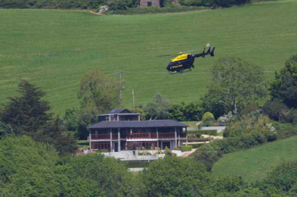 12 May 2020 - 13-40-21 
The house used to have a helicopter landing pad. Usually known as 'the croquet lawn'.
----------------------
Devon & Cornwall Police helicopter G-DCPB